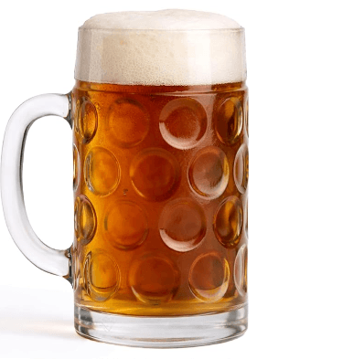 Dimpled glass mug of amber beer with a thick foam head on a white background