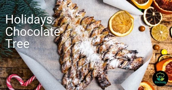 Banner reading Holidays Chocolate Tree over a chocolate puff pastry tree dusted with sugar