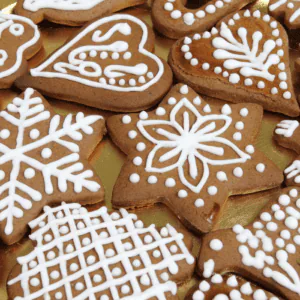 Gingerbread cookies cut as snowflakes, stars and hearts and piped with white royal icing