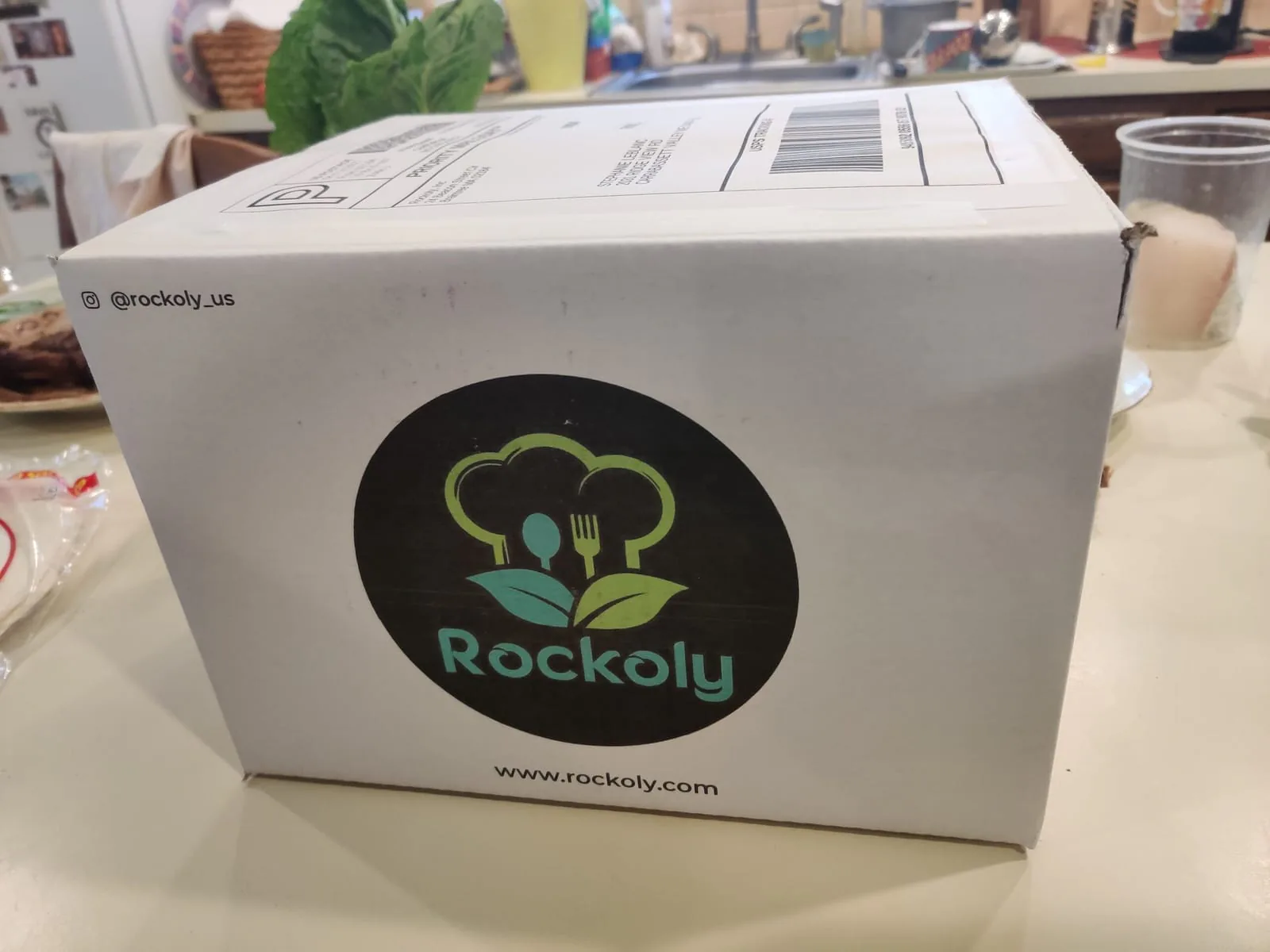 White meal kit shipping box printed with the Rockoly logo and web address