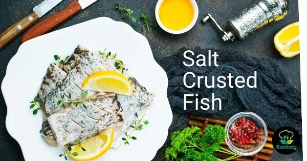 Banner reading Salt Crusted Fish over a plate of white fish fillets with lemon and thyme