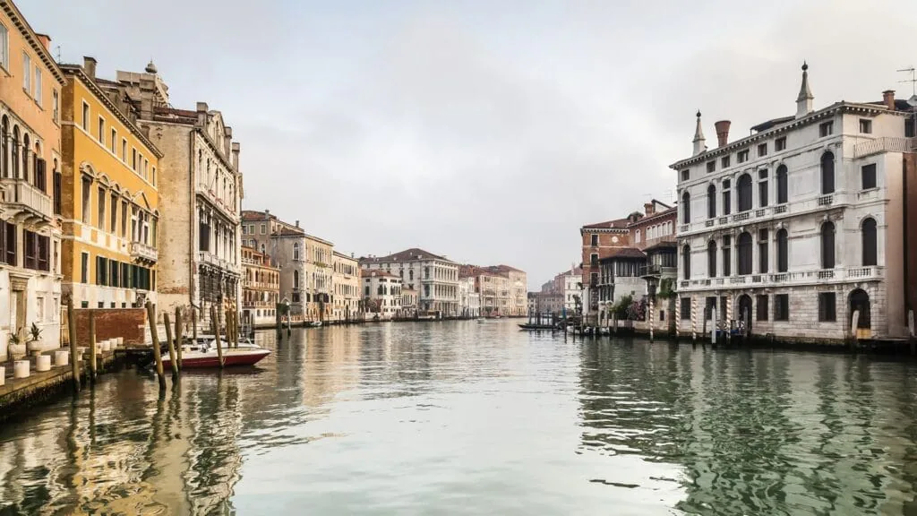 Venice’s Grand Canal lined with historic palazzos under an overcast sky