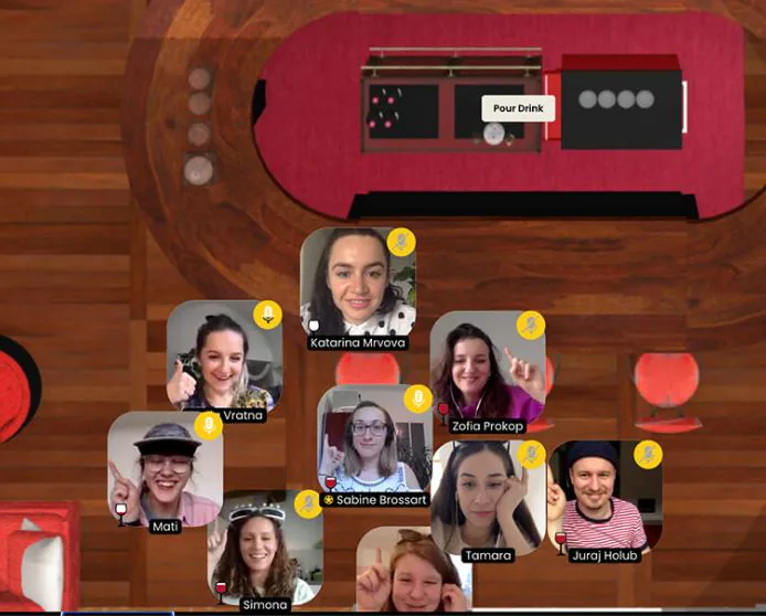 Virtual happy hour platform with participant video tiles gathered around an online bar and a Pour Drink button