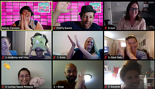 Nine people laughing on a video call game show, some wearing costumes and holding props