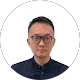 Owen Su wearing glasses and a dark collared shirt against a plain white background