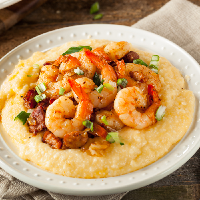 Cajun shrimp and andouille sausage piled on creamy corn grits with sliced scallions