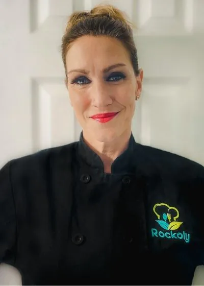 Chef Heidi with her hair pinned up, wearing a black Rockoly chef coat