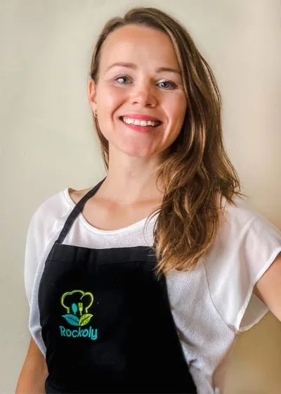 Chef Lenka smiling in a white tee and a black Rockoly apron