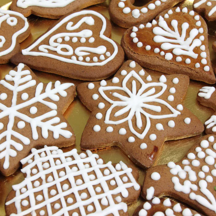 Gingerbread cookies cut as stars, hearts and snowflakes, piped with white royal icing