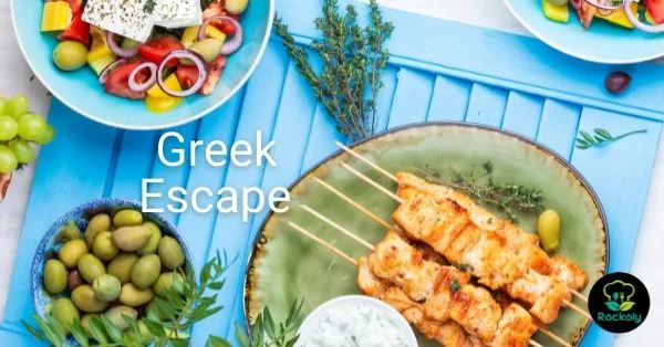 Banner reading Greek Escape, with chicken souvlaki skewers, Greek salad, olives and tzatziki