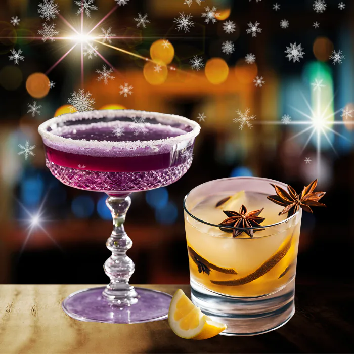 Purple sugar-rimmed holiday cocktail beside an amber drink with star anise and orange, with sparkles