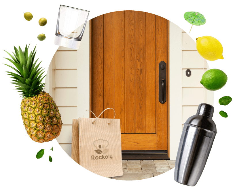 Rockoly kraft delivery bag on a front doorstep surrounded by pineapple, citrus, mint and a cocktail shaker