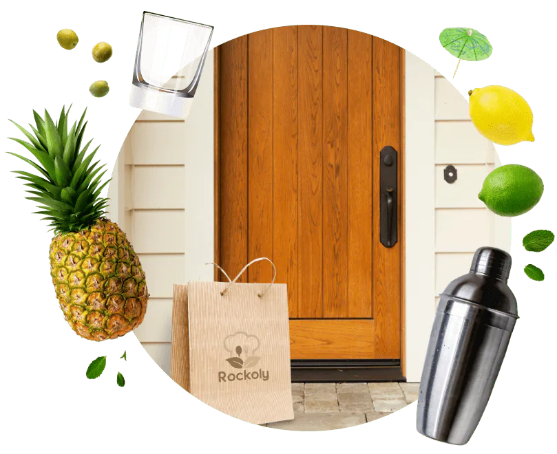 Rockoly kraft delivery bag on a front doorstep surrounded by pineapple, citrus, mint and a cocktail shaker