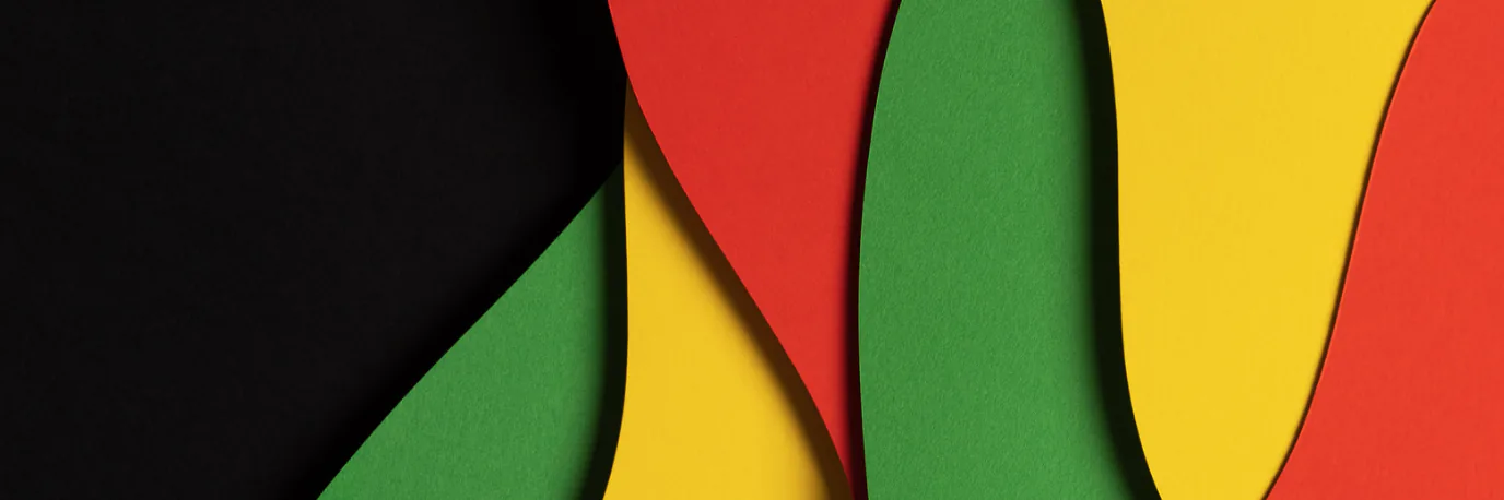 Layered paper cutouts in black, red, yellow and green, the Pan-African colors
