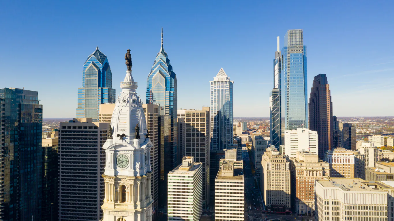 Aerial view of the Philadelphia skyline with City Hall's clock tower and statue in the foreground