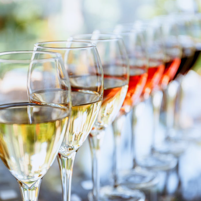 Close-up of glasses of white wine lined up on a table for a tasting