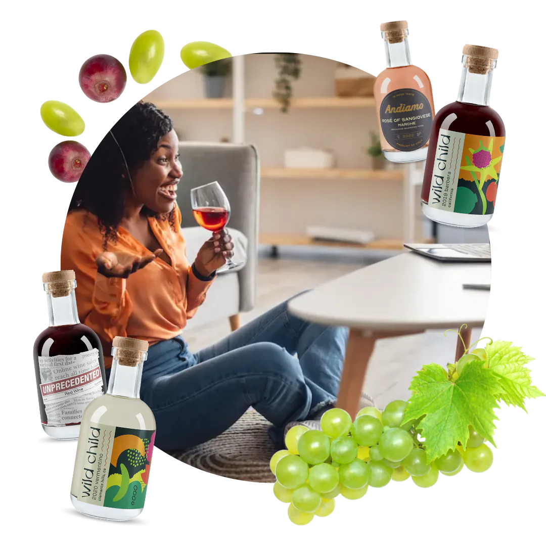 Woman sipping red wine at home surrounded by wine kit bottles labelled Andiamo, Wild Child and Unprecedented