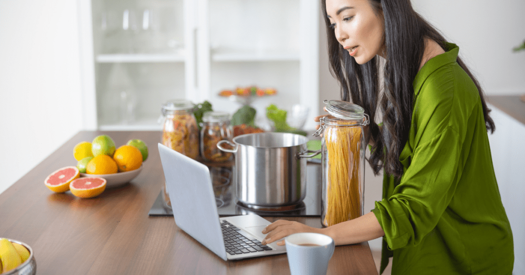 Woman taking an online chef led cooking class while at home